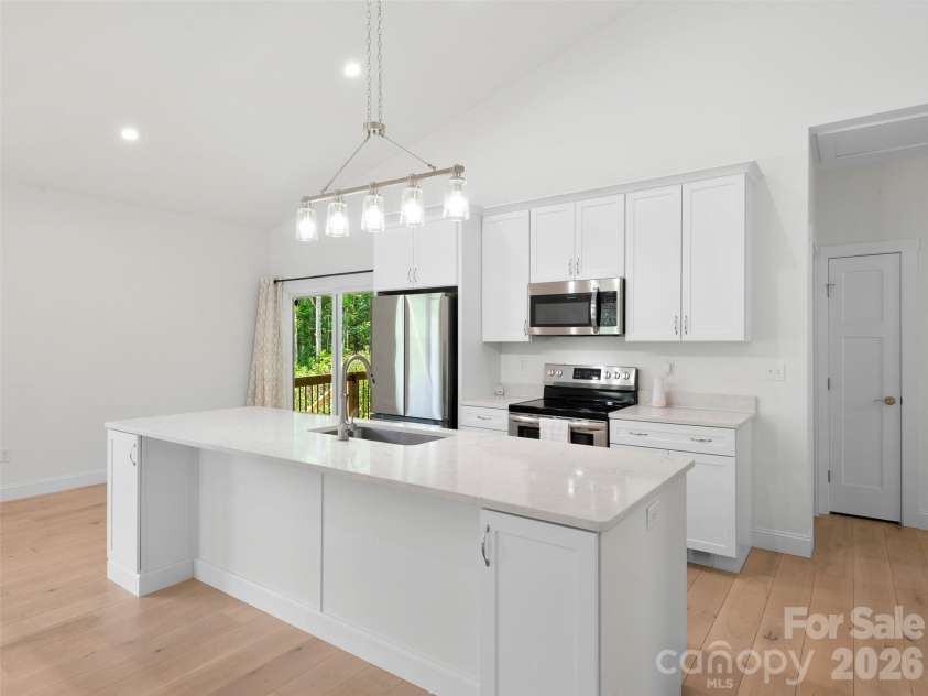 201 Mapleton Drive, East Flat Rock, NC 28726.  MLS# CAR4404187, YatesRealty ID 41286. Well-appointed kitchen featuring modern finishes, ample cabinetry, and generous counter space.