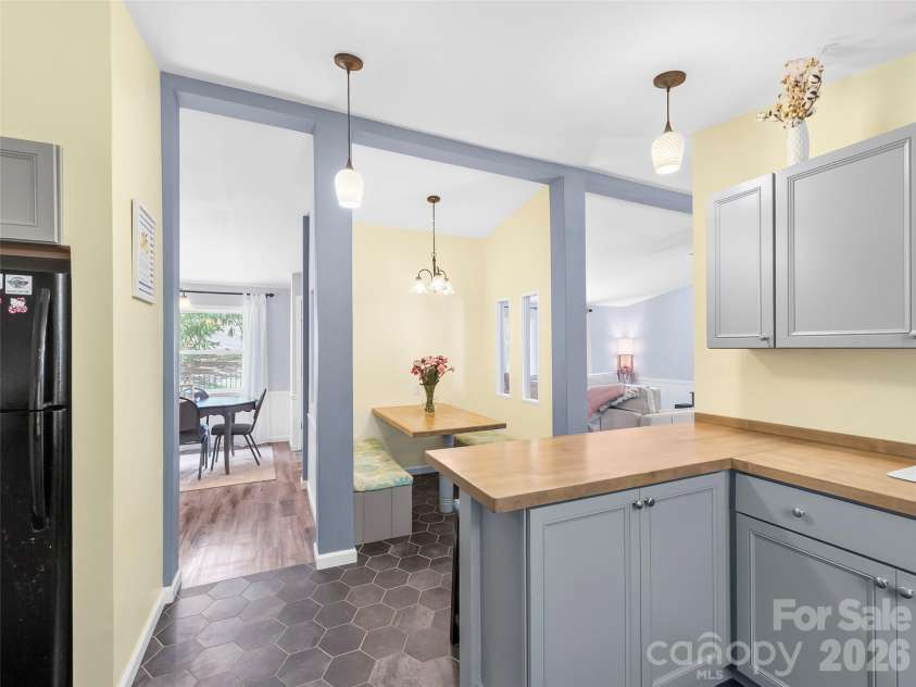 32 Reeves Road, Leicester, NC 28748.  MLS# CAR4407288, YatesRealty ID 41329. Kitchen to eating nook and formal dining