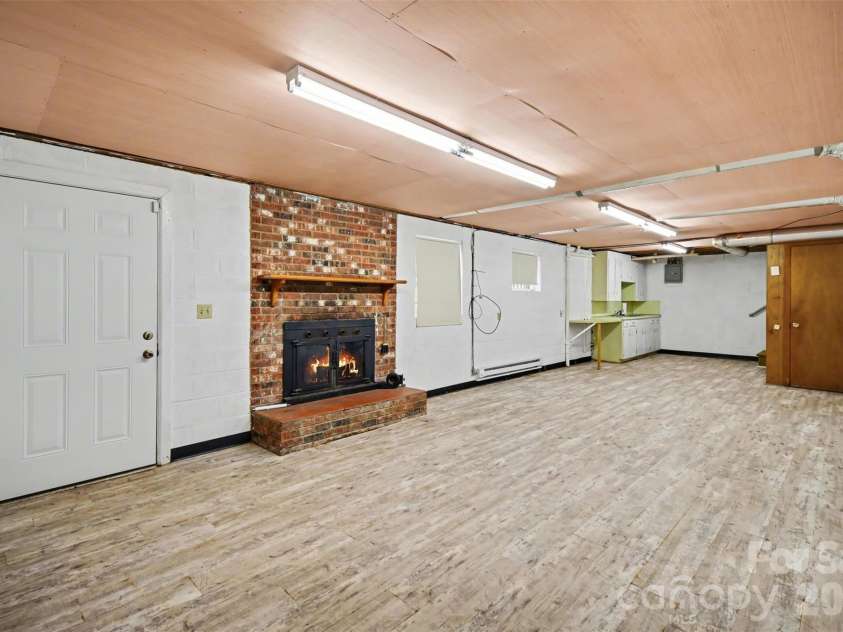 1300 Briarcliff Road, Shelby, NC 28152.  MLS# CAR4375199, YatesRealty ID 41360. Downstairs living room fireplace