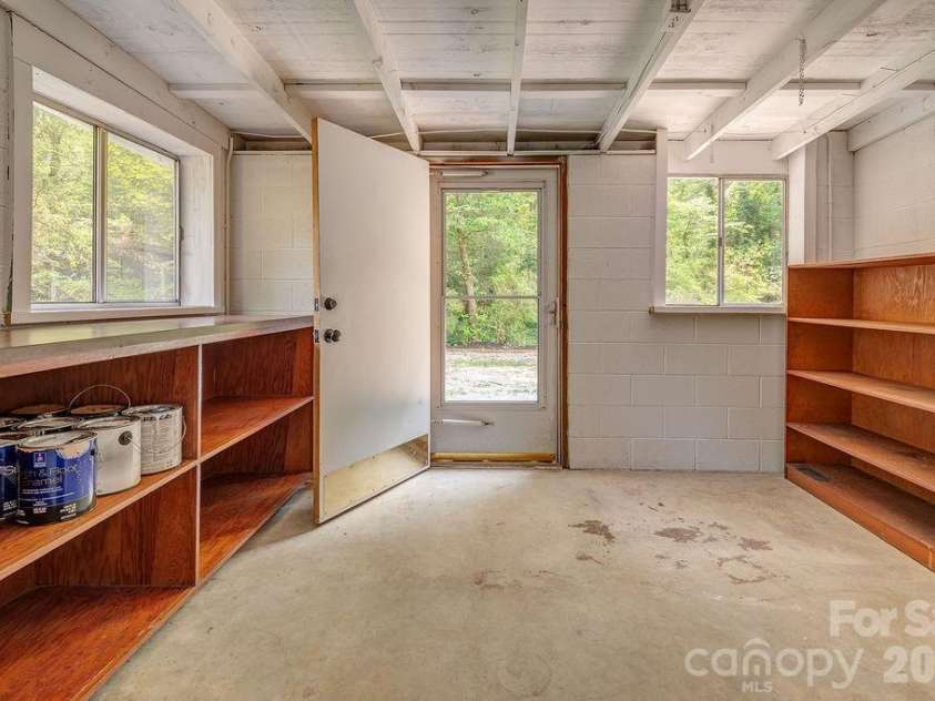 47 Bell Road, Asheville, NC 28805.  MLS# CAR4402411, YatesRealty ID 41364. Basement workshop with exterior access.