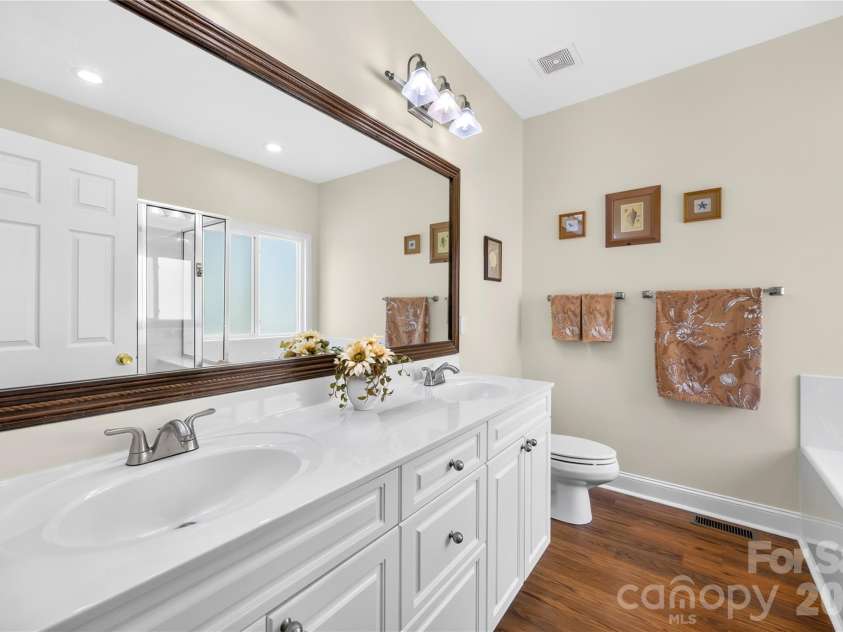 144 Quail Haven Drive, Troutman, NC 28166.  MLS# CAR4401635, YatesRealty ID 41381. Primary bath has two basin vanity