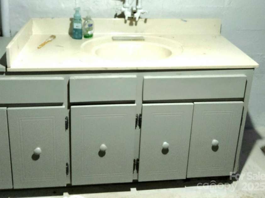 1294 Cane Creek Road, Bakersville, NC 28705.  MLS# CAR4291675, YatesRealty ID 414. Lower-level utility sink area