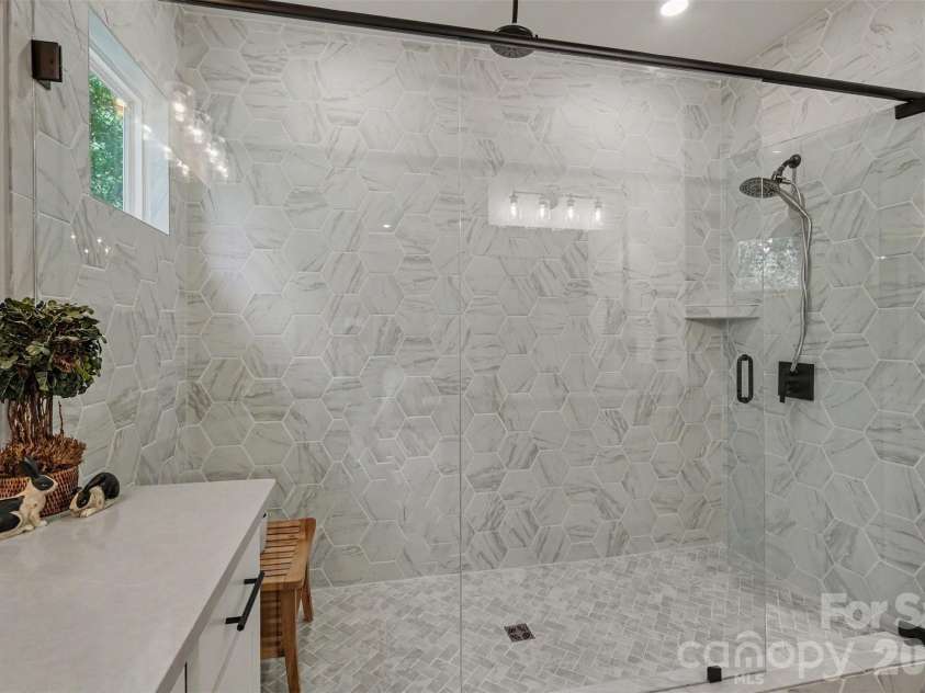 4128 Merkland Lane, Charlotte, NC 28226.  MLS# CAR4409085, YatesRealty ID 41414. Oversized primary shower with ceiling mounted rain head