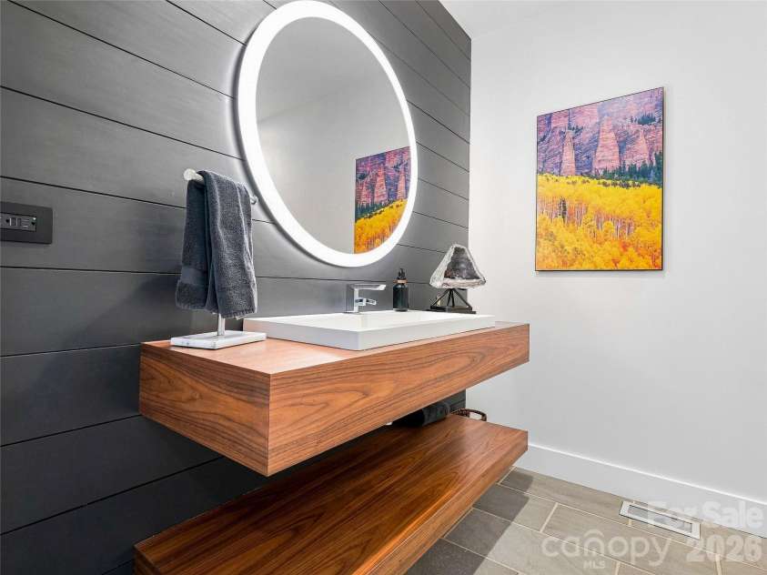 25 Bartrams Walk Drive, Asheville, NC 28804.  MLS# CAR4402146, YatesRealty ID 41418. Stunning floating sink in the main floor powder room.