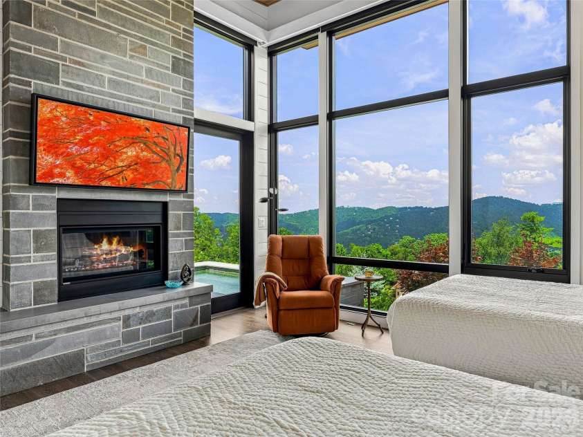 25 Bartrams Walk Drive, Asheville, NC 28804.  MLS# CAR4402146, YatesRealty ID 41418. The primary suite is on main with floor to ceiling windows with automatic blinds.