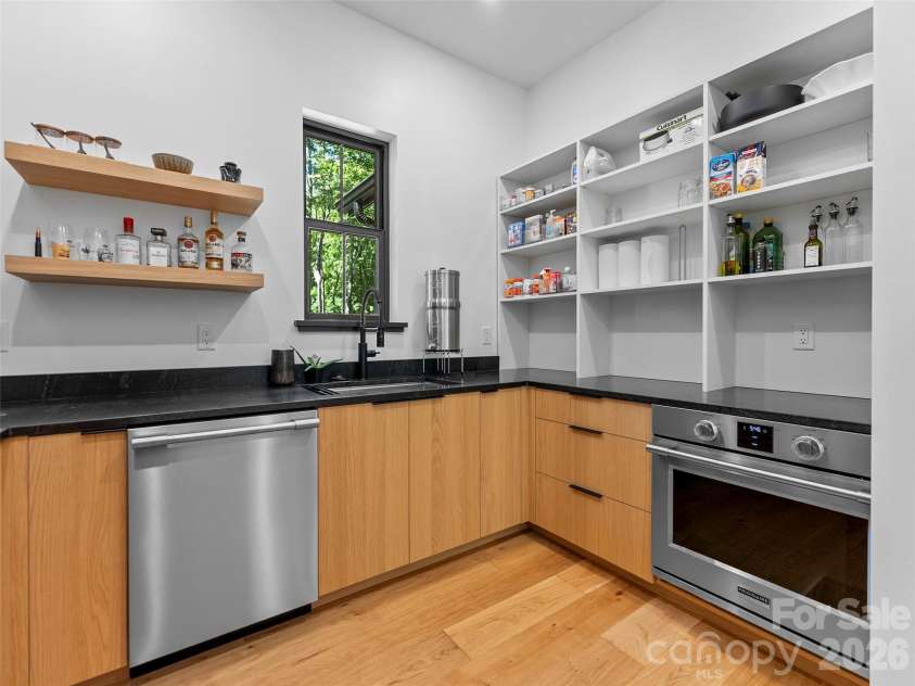 80 Maple Grove Court, Hendersonville, NC 28792.  MLS# CAR4409881, YatesRealty ID 41559. This generously sized catering kitchen featurning a 2nd dishwasher and a 3rd oven keeps the mess behind the scenes, giving the main kitchen room to shine while making entertaining remarkably effortless.