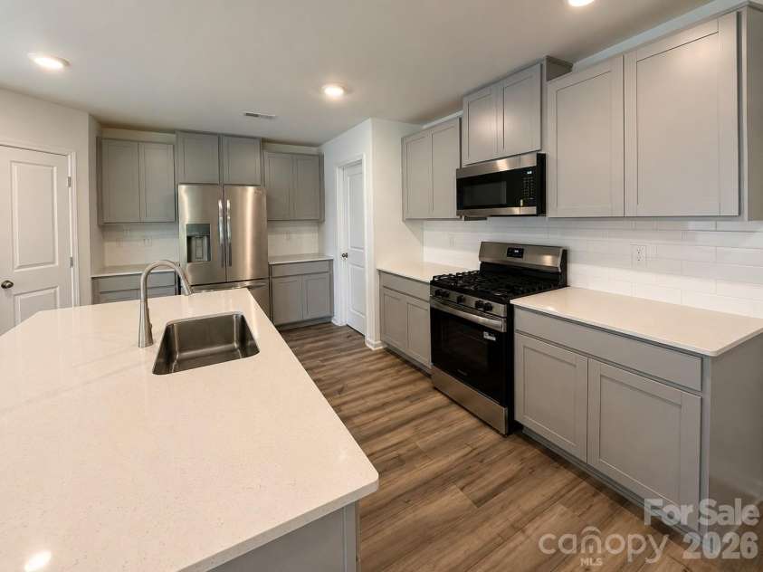 161 Spotted Way, Troutman, NC 28166.  MLS# CAR4406028, YatesRealty ID 41562. Gorgeous kitchen wtih refrigerator
