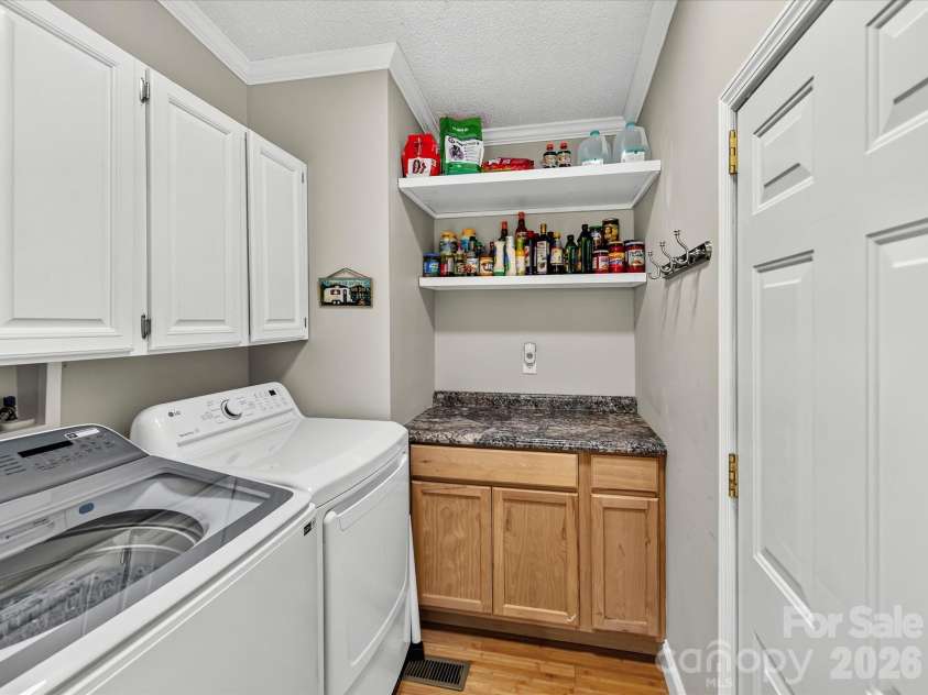 4486 Graybirch Drive, Maiden, NC 28650.  MLS# CAR4409913, YatesRealty ID 41573. Laundry Room with ample built in cabinetry & shelving.