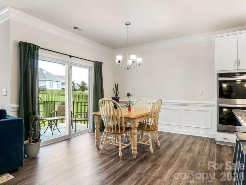 4197 Millstream Road, Denver, NC 28037.  MLS# CAR4408202, YatesRealty ID 41586. Gather around this stunning kitchen-dining combination spanning nearly 400 square feet. Granite countertops, custom cabinetry, and designer backsplash tile showcase quality in every detail.