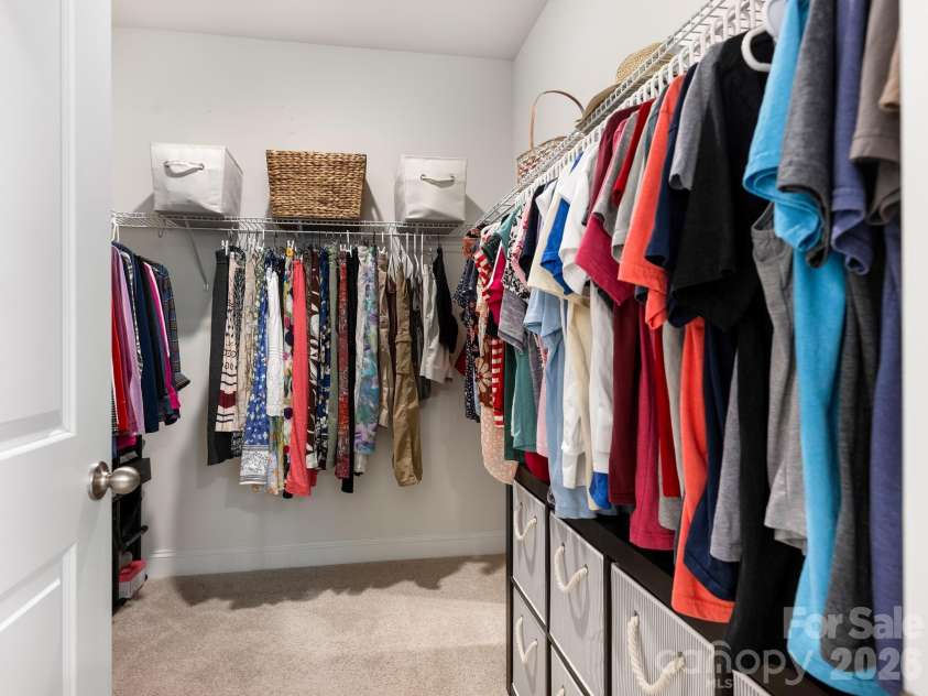 4197 Millstream Road, Denver, NC 28037.  MLS# CAR4408202, YatesRealty ID 41586. Organize in style with this spacious walk-in closet featuring multiple rods and shelving. Ample space ensures everything has its place in this well-designed storage solution.