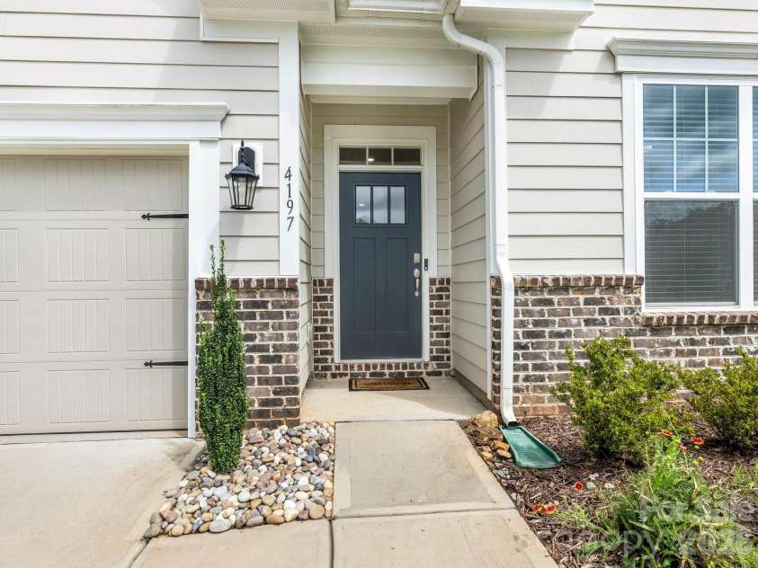 4197 Millstream Road, Denver, NC 28037.  MLS# CAR4408202, YatesRealty ID 41586. Stunning first impression with stone veneer entry, professional landscaping, and quality construction details. The covered front porch provides a gracious welcome to guests and protection from the elements.