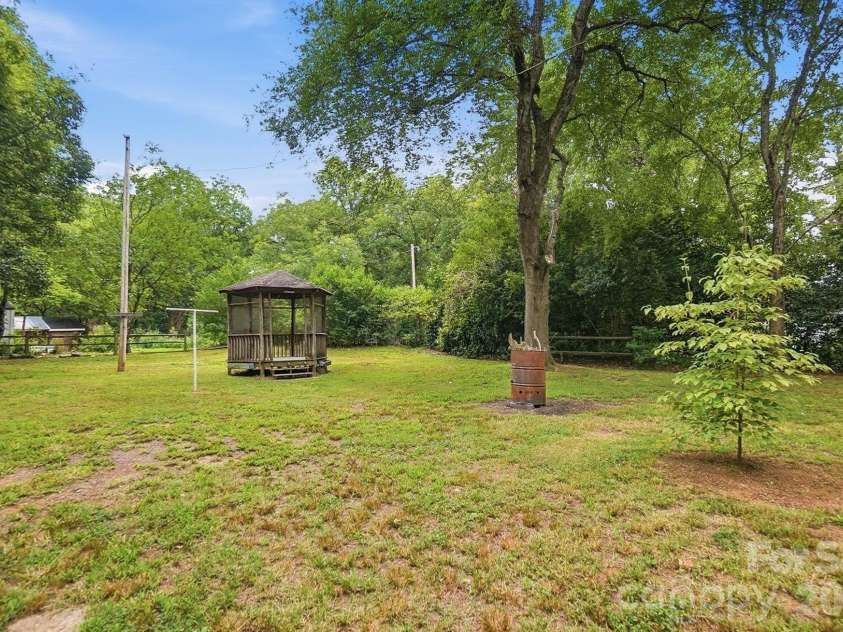 419 Jackson Street, Albemarle, NC 28001.  MLS# CAR4408886, YatesRealty ID 41626. Flat backyard surrounded by mature trees