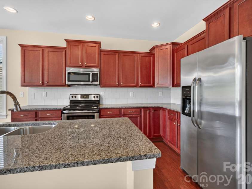 127 Johnson Manor Street, Mooresville, NC 28115.  MLS# CAR4407798, YatesRealty ID 41663. Kitchen with granite
