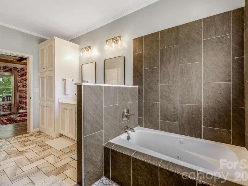 21 Old Pinner Place, Arden, NC 28704.  MLS# CAR4407827, YatesRealty ID 41672. Massive tub and shower in primary bathroom