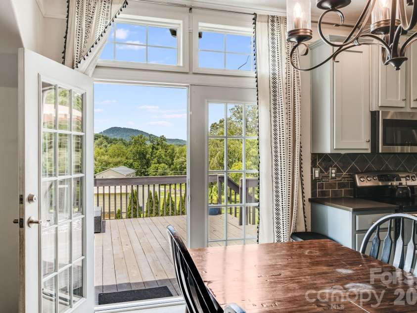 21 Old Pinner Place, Arden, NC 28704.  MLS# CAR4407827, YatesRealty ID 41672. Sit a spell on the private back porch with mountain views.