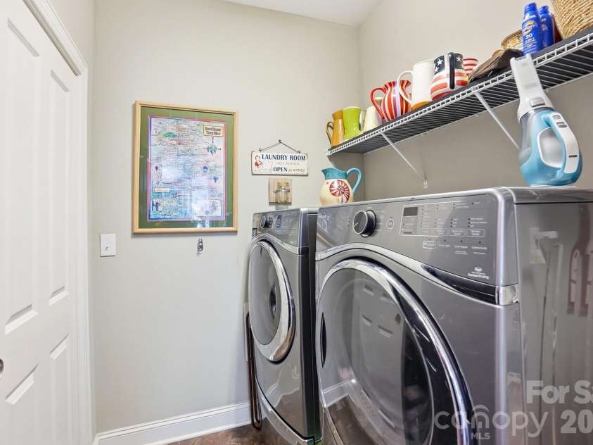 1100 Avalon Place, Matthews, NC 28104.  MLS# CAR4411415, YatesRealty ID 41696. Large main floor laundry with storage area