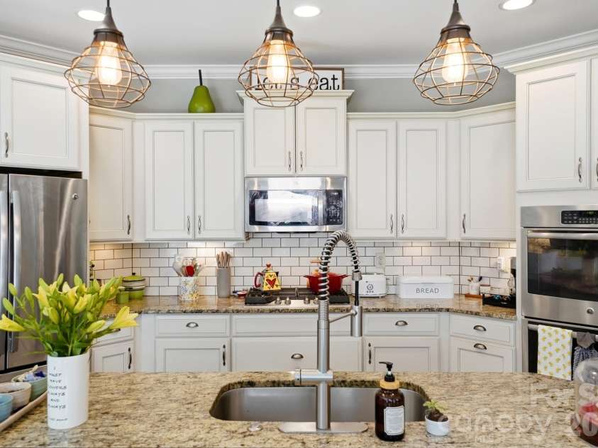 1100 Avalon Place, Matthews, NC 28104.  MLS# CAR4411415, YatesRealty ID 41696. Updated pendant lighting over island