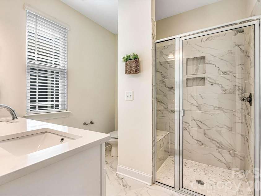 2011 Claybrook Lane, Denver, NC 28037.  MLS# CAR4410531, YatesRealty ID 41699. Primary ensuite tiled shower with bench seating