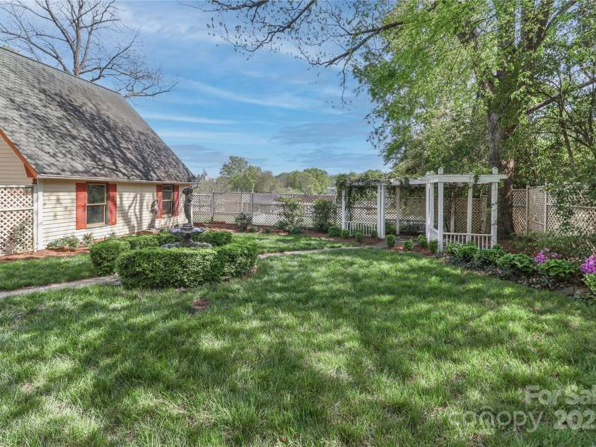 235 Walnut Street, Statesville, NC 28677.  MLS# CAR4134450, YatesRealty ID 418. Arbor in the backyard with sitting area.