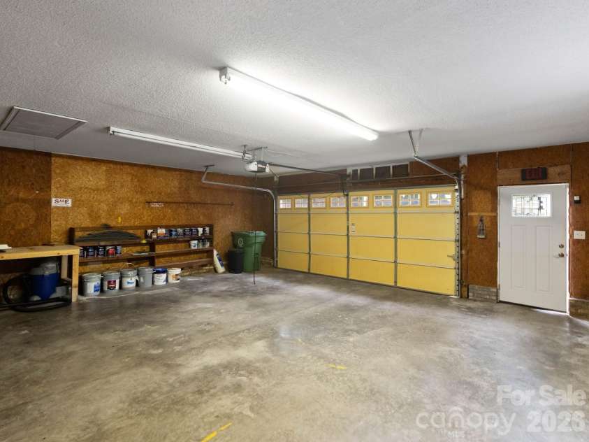 110 Sawtooth Lane, Stanley, NC 28164.  MLS# CAR4409490, YatesRealty ID 41865. View of the interior detached garage featuring work bench and pull down attic space