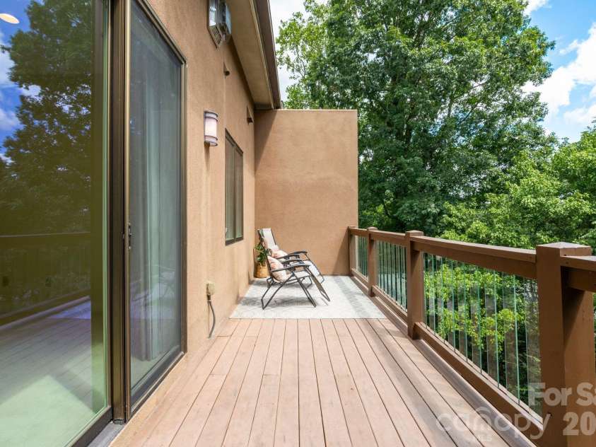 26 Macallan Lane, Asheville, NC 28805.  MLS# CAR4401347, YatesRealty ID 41888. Upper level balcony / deck off Primary Suite.