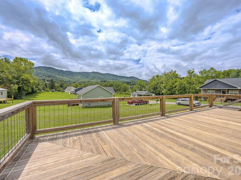 160 Ridge View Drive, Clyde, NC 28721.  MLS# CAR4411209, YatesRealty ID 41946. Long range mountain views off the back/side porch