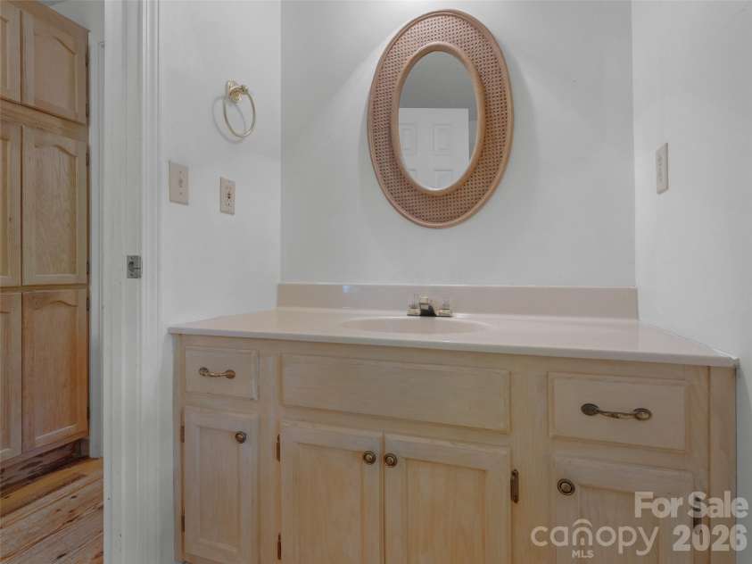 95 Substation Road, Saluda, NC 28773.  MLS# CAR4402765, YatesRealty ID 42020. Half bathroom by the laundry room