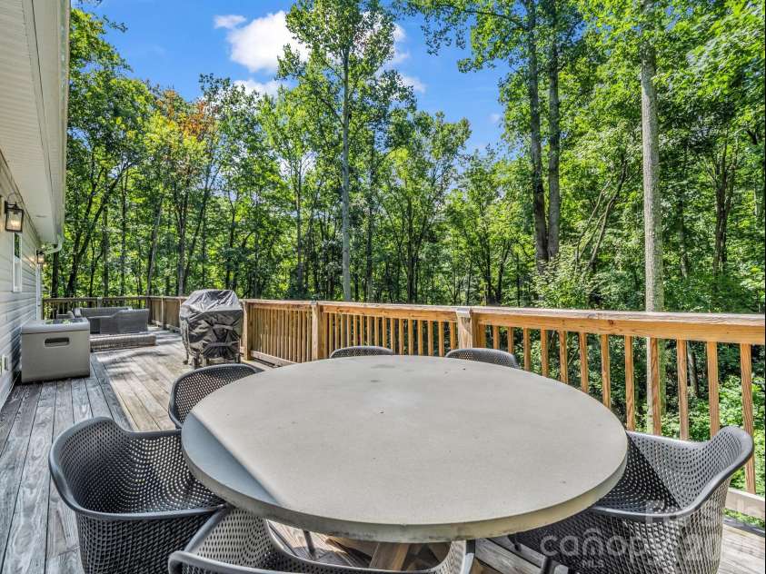 180 Ridgeview Drive, Hendersonville, NC 28792.  MLS# CAR4410645, YatesRealty ID 42029. Large back deck with table, chairs, and propane gas fire pit.  All available for purchase.