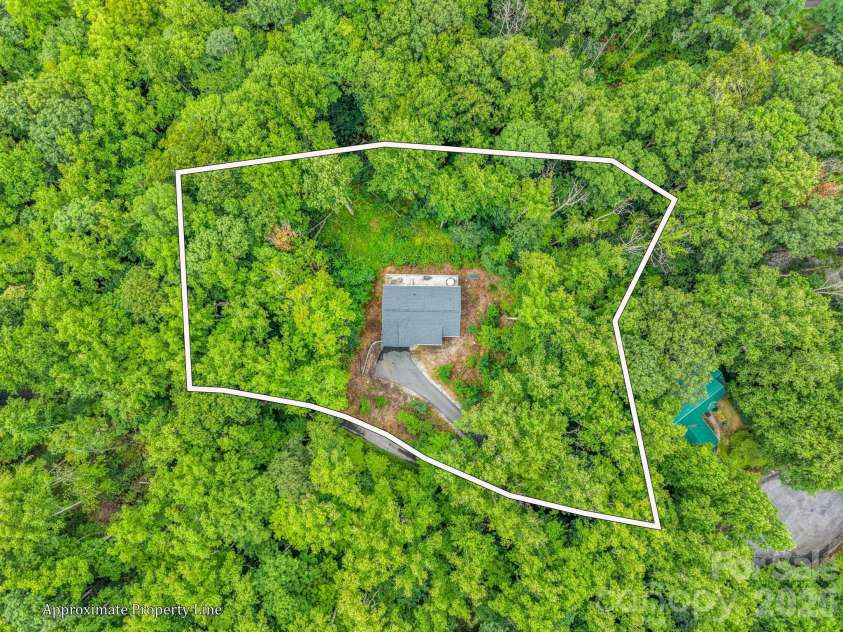 180 Ridgeview Drive, Hendersonville, NC 28792.  MLS# CAR4410645, YatesRealty ID 42029. Private setting, surrounded by trees.