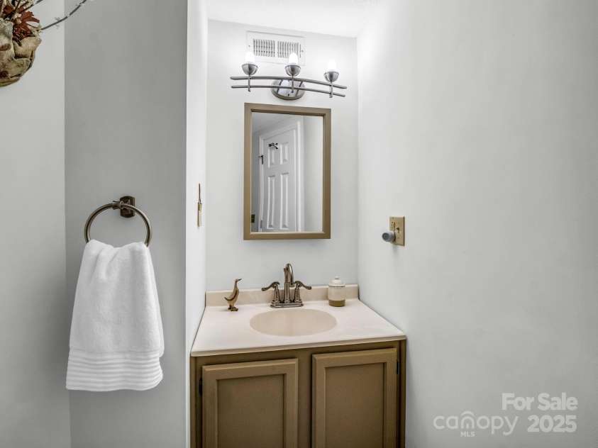 193 Downing Place, Lake Lure, NC 28746.  MLS# CAR4280208, YatesRealty ID 4203. Guest bathroom with a walk-in shower in the finished walk-out basement.