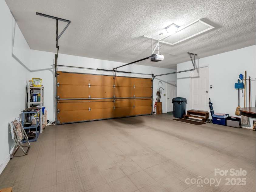 193 Downing Place, Lake Lure, NC 28746.  MLS# CAR4280208, YatesRealty ID 4203. Two-car garage finished with a floormat system.