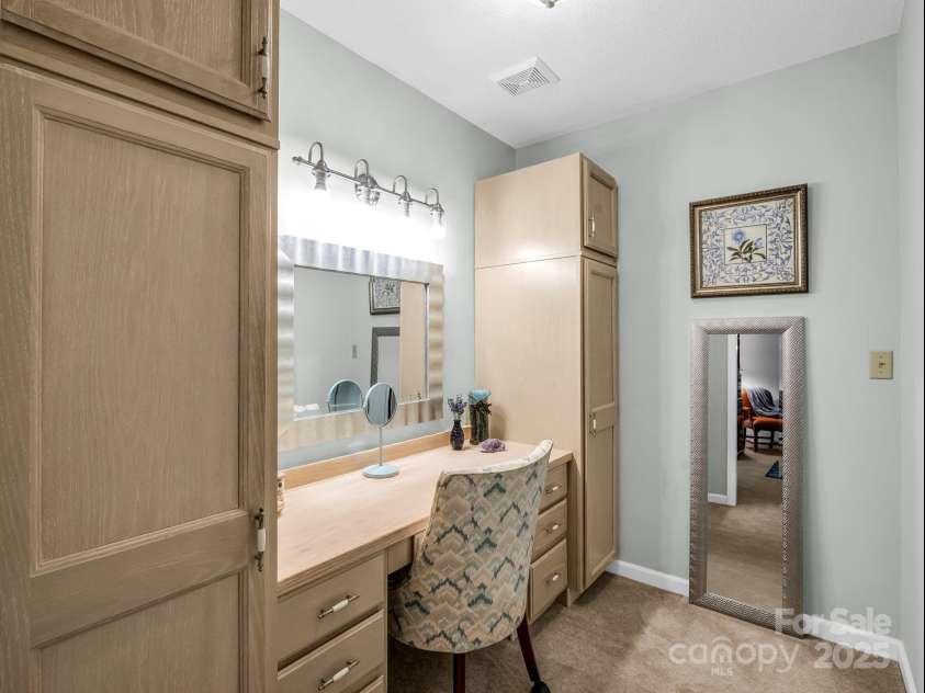 193 Downing Place, Lake Lure, NC 28746.  MLS# CAR4280208, YatesRealty ID 4203. Walk-in changing room, with built-in vanity, storage cabinets, and another walk-in closet for hanging garments and storage.
