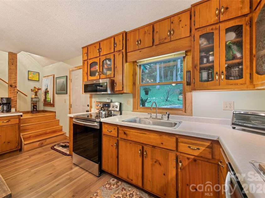 294 Laurel Branch Road, Maggie Valley, NC 28751.  MLS# CAR4411437, YatesRealty ID 42056. Kitchen and stairs to upper level