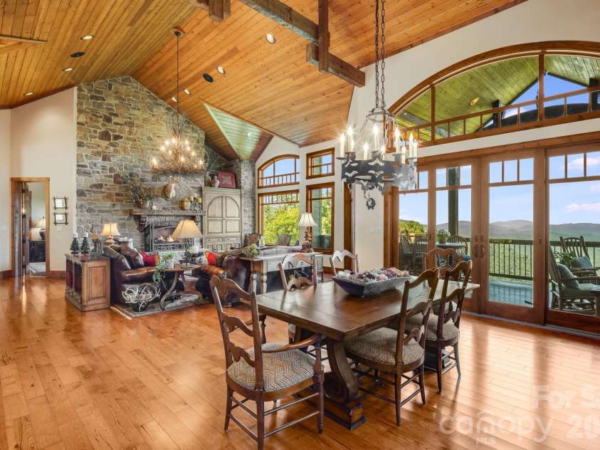 817 Running Cedar Lane, Mars Hill, NC 28754.  MLS# CAR4407984, YatesRealty ID 42073. Designed for gathering, the open great room and dining area are crowned by soaring wood ceilings and an impressive framework of exposed timber rafters and beams. Their rich tones and substantial scale add warmth, cr