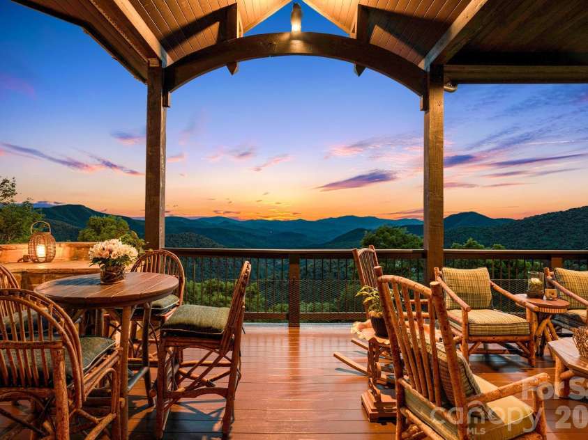 817 Running Cedar Lane, Mars Hill, NC 28754.  MLS# CAR4407984, YatesRealty ID 42073. Sweeping layers of the Blue Ridge Mountains create an unforgettable backdrop for outdoor living from the covered back deck.