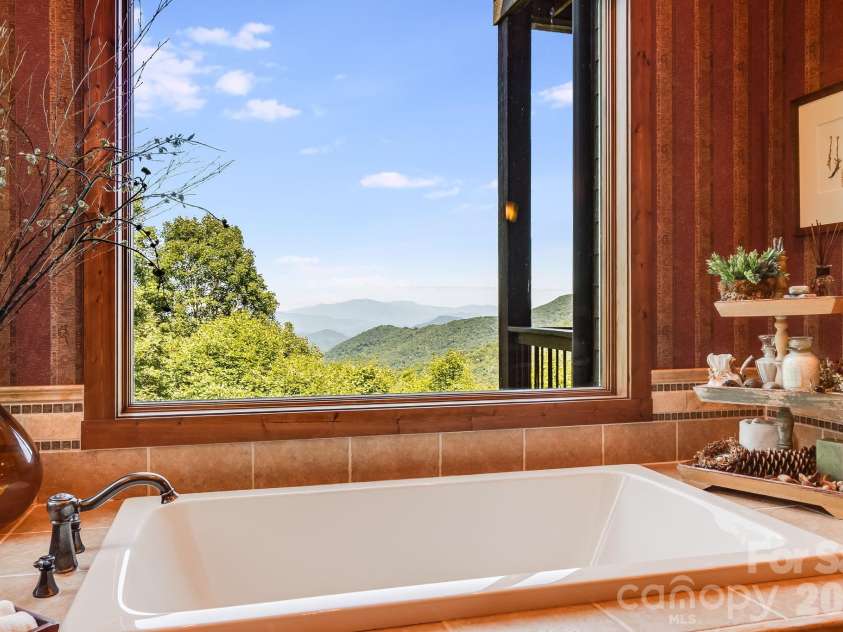 817 Running Cedar Lane, Mars Hill, NC 28754.  MLS# CAR4407984, YatesRealty ID 42073. Unwind in the jetted soaking tub while taking in breathtaking, long-range views across the layered Blue Ridge Mountains.