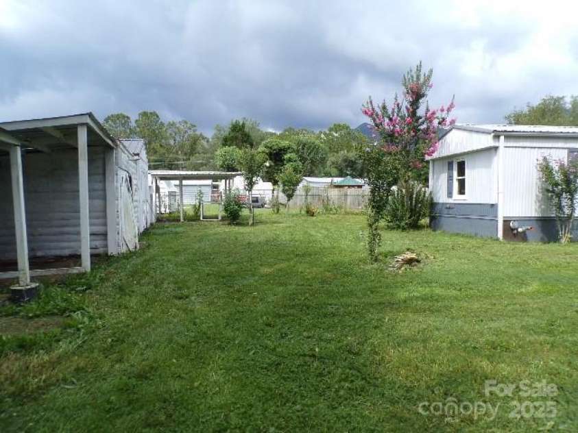 71 Flat Creek Road, Waynesville, NC 28785.  MLS# CAR4289223, YatesRealty ID 4211. Side yard