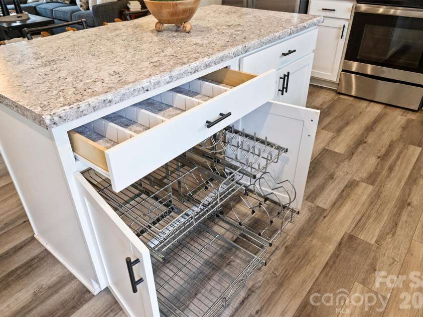 7016 Ludell Lane, Charlotte, NC 28215.  MLS# CAR4410902, YatesRealty ID 42112. Pull out shelves in the cabinets, and pull-out trash.