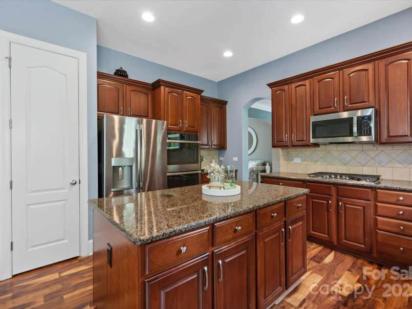 11308 Wheat Ridge Road, Charlotte, NC 28277.  MLS# CAR4241331, YatesRealty ID 4212. Double wall oven and walk-in pantry with custom shelving