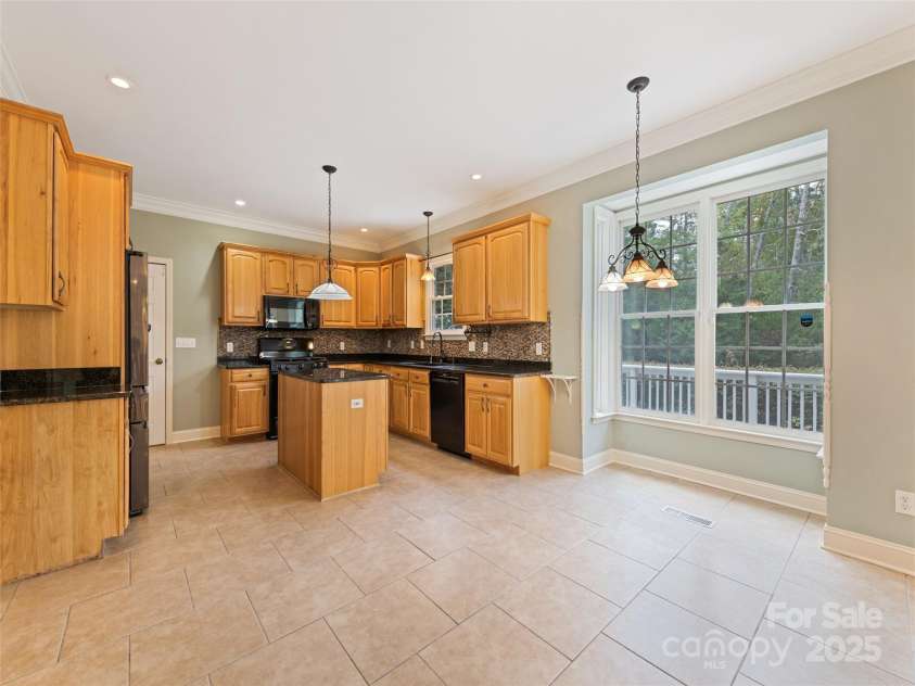 6 Dogwood Lane, Fletcher, NC 28732.  MLS# CAR4302762, YatesRealty ID 4219. Kitchen with eat in area overlooking beautiful backyard