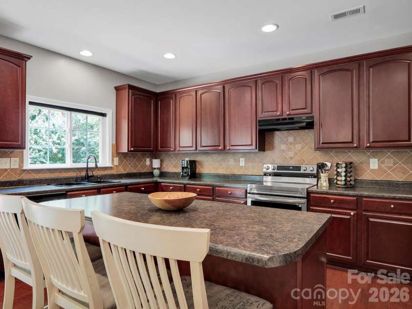 4908 Cruz Bay Drive, Monroe, NC 28110.  MLS# CAR4409228, YatesRealty ID 42226. Kitchen with a center island and rich cabinetry