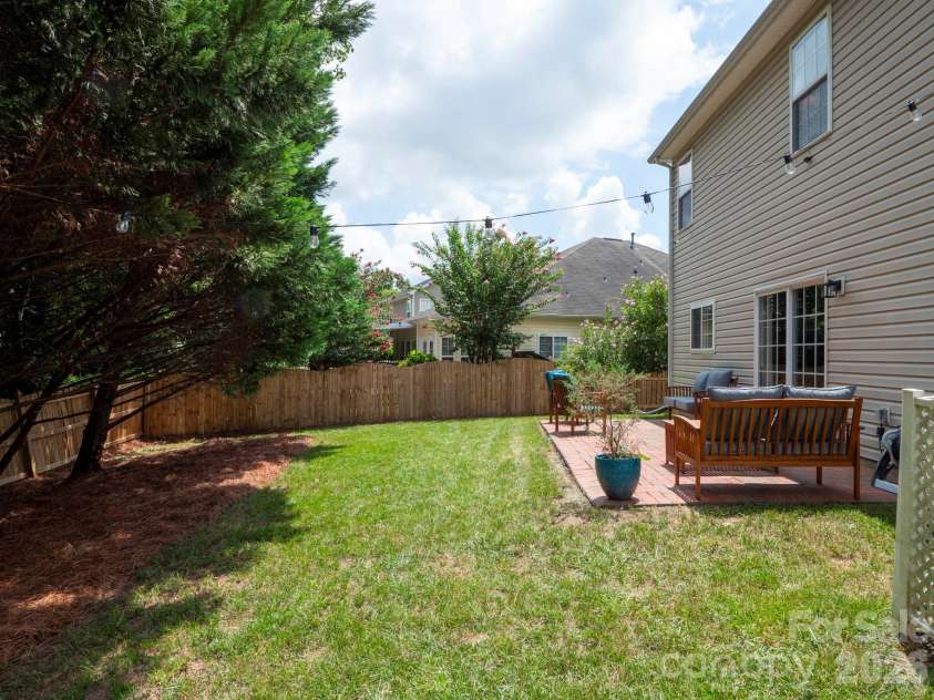 4908 Cruz Bay Drive, Monroe, NC 28110.  MLS# CAR4409228, YatesRealty ID 42226. Level, fenced backyard ready for cookouts and play