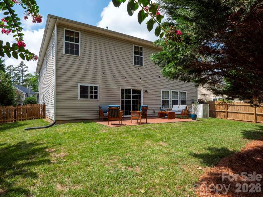 4908 Cruz Bay Drive, Monroe, NC 28110.  MLS# CAR4409228, YatesRealty ID 42226. Private backyard framed by mature trees