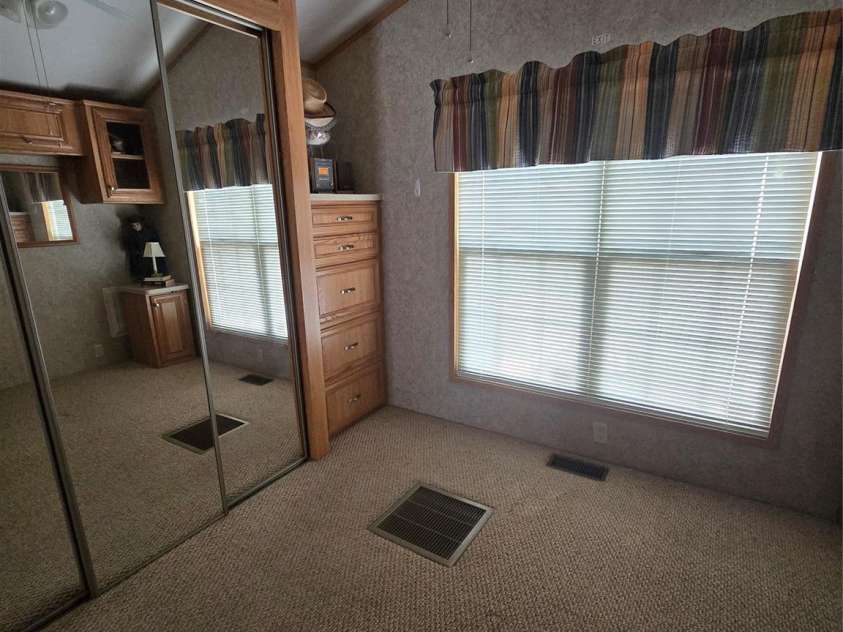 110 Twin Bluff Trail, Mount Gilead, NC 27306.  MLS# CAR4409542, YatesRealty ID 42258. Primary bedroom different angle full closets w mirror doors & built-in chest in corner