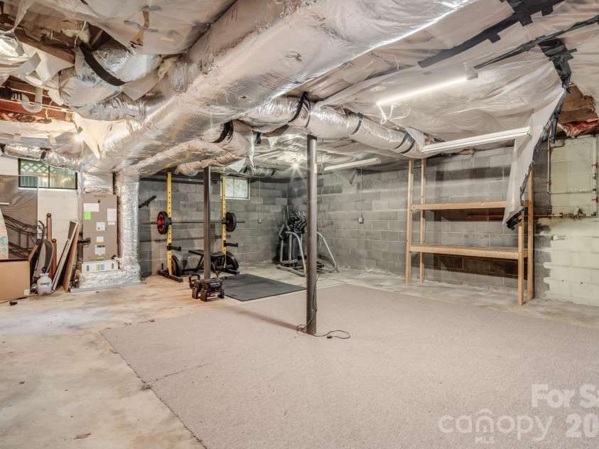 10 Davenport Place, Asheville, NC 28806.  MLS# CAR4383059, YatesRealty ID 42328. Large unfinished basement with exceptional storage capacity and versatile flex space