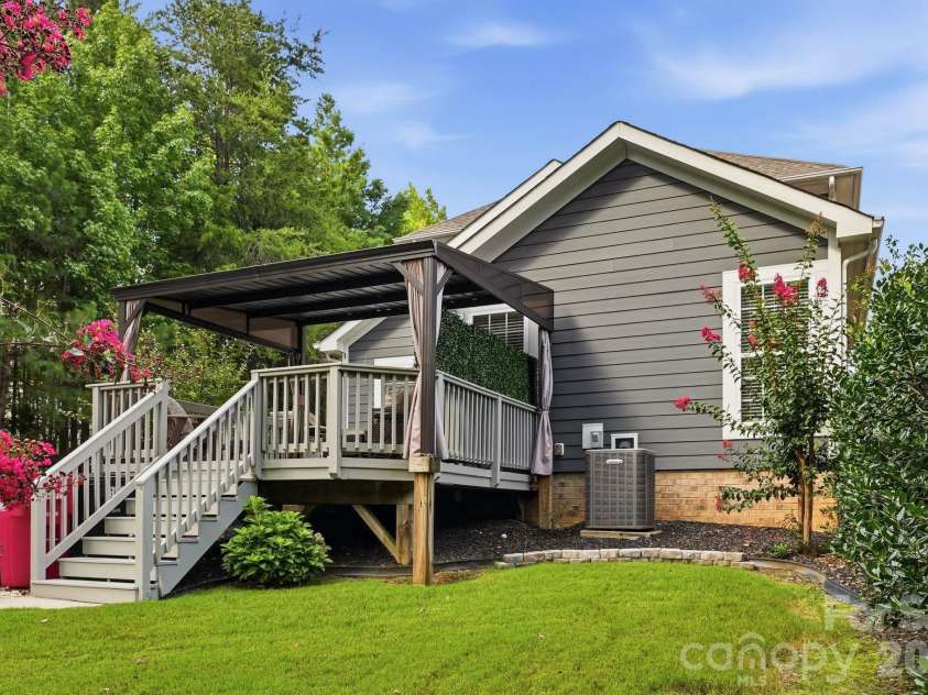 18609 Boulder Rock Loop, Davidson, NC 28036.  MLS# CAR4411962, YatesRealty ID 42335. A view from the lush backyard showcases the expansive deck and inviting outdoor living space.