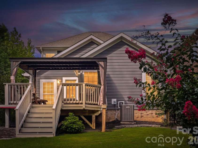 18609 Boulder Rock Loop, Davidson, NC 28036.  MLS# CAR4411962, YatesRealty ID 42335. Beautifully illuminated at twilight, this charming Davidson home offers a warm welcome and timeless curb appeal.