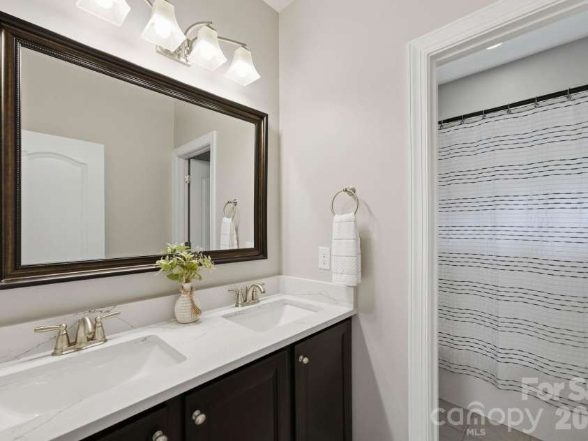 18609 Boulder Rock Loop, Davidson, NC 28036.  MLS# CAR4411962, YatesRealty ID 42335. Convenient Jack-and-Jill bathroom connects the two secondary bedrooms and features a dual-sink vanity with ample counter space and storage.