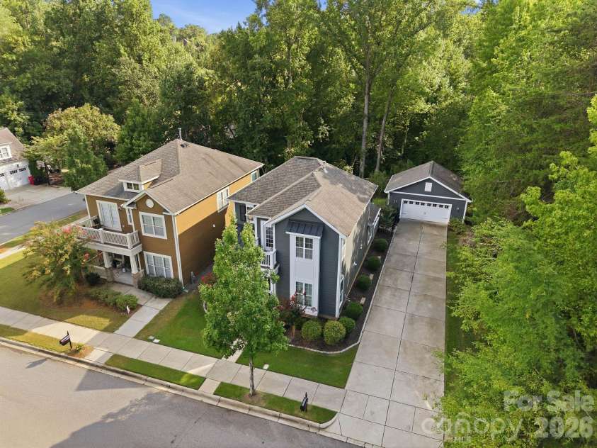 18609 Boulder Rock Loop, Davidson, NC 28036.  MLS# CAR4411962, YatesRealty ID 42335. High aerial view showcases the expansive driveway, detached garage, and mature trees surrounding the property.