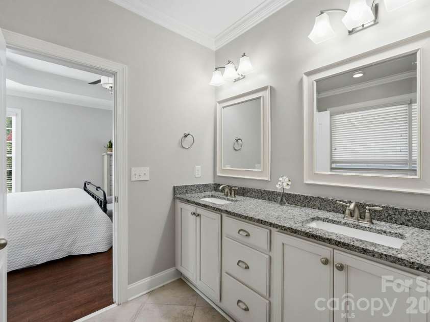 18609 Boulder Rock Loop, Davidson, NC 28036.  MLS# CAR4411962, YatesRealty ID 42335. Primary bath with dual sinks, granite countertops, and abundant vanity storage.